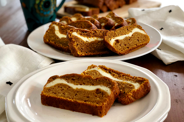 Pumpkin Bread with Cream Cheese Filling | This easy recipe with Greek yogurt bakes up a moist pumpkin bread stuffed with slightly sweetened cream cheese and spiced perfectly with homemade pumpkin pie spice!