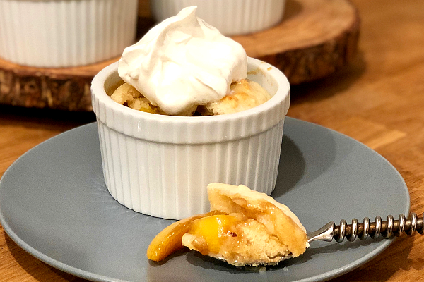 Individual Peach Cobbler | Sweet peaches baked with brown sugar and topped with a soft biscuit...yes please! Pass me that peach cobbler!
